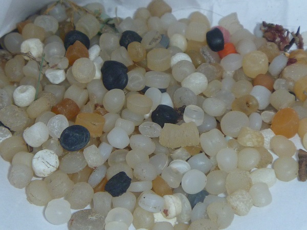 Close-up photo of plastic resin pellets, also called nurdles.