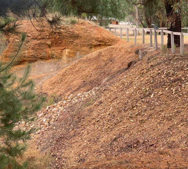 Worked alluvium made up of orange and white gravel and rock 